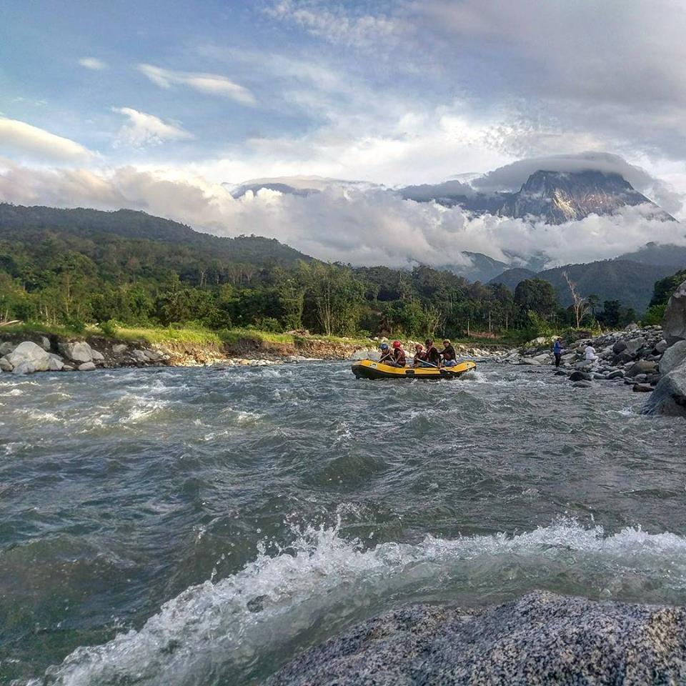 Raft along the Kadamaian river with Mount Kinabalu as your backdrop.